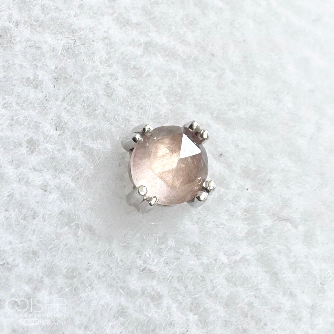 white gold earring with a central rose quartz gemstone on a white background