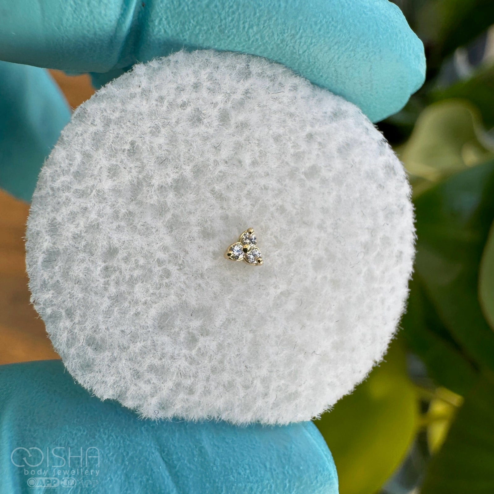 Gold and diamond earring on a white background
