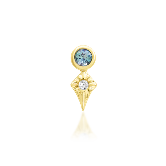Gold earring with blue gemstone on a white background