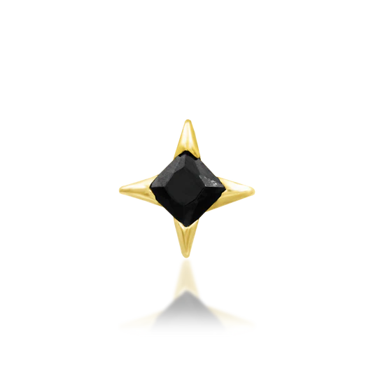 Gold pendant with a black gemstone on a white background