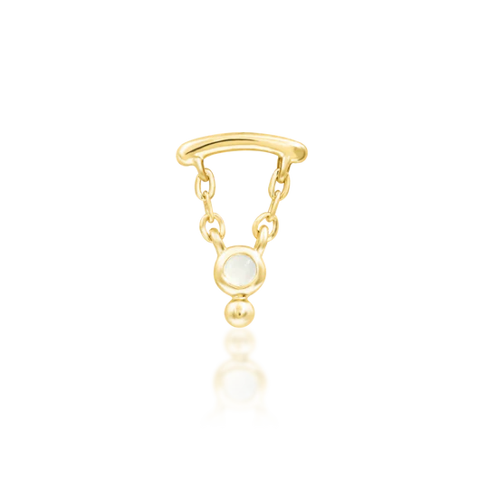 Gold earring with a moonstone gem on a white background