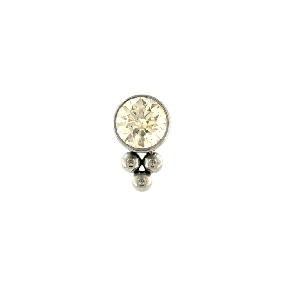 Jewelry champagne earring with a central gemstone on a white background