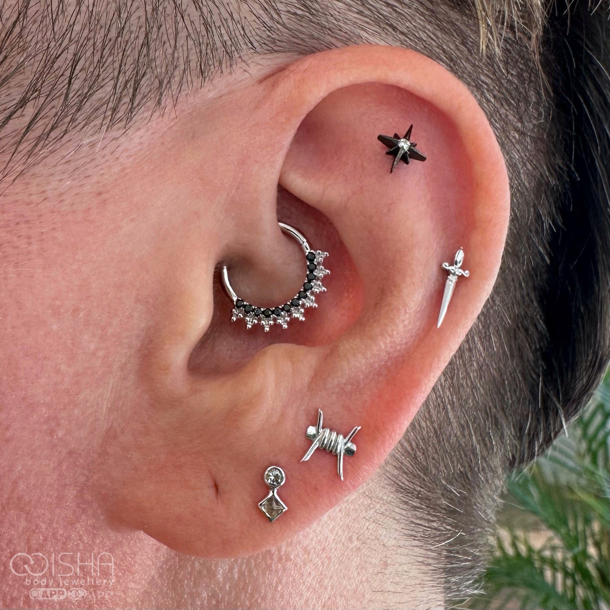 Gold hoop earrings with gemstone accents on a white background